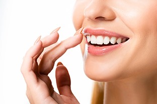 a person smiling after getting cosmetic bonding