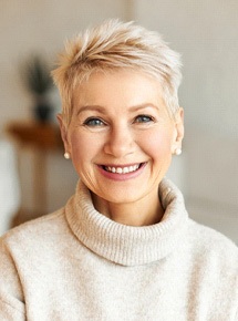 a woman in Peabody smiling with her new dentures