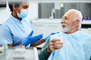 a patient talking with his dentist about dentures