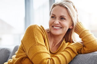 a woman smiling with her new dentures in Peabody