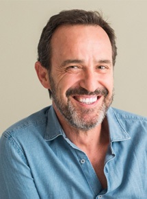 a man smiling with implant dentures in Peabody