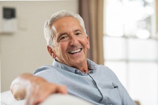 a man smiling with implant dentures in Peabody