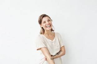 a woman smiling with implant dentures in Peabody