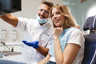 patient admiring her new smile with dental implants in Peabody