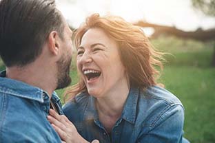 man and woman laughing together