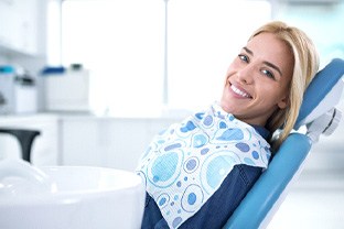 Smiling woman sitting in dental office