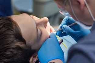 A teenager receiving dental sealants