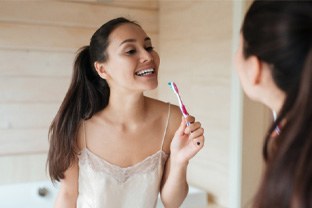 Woman brushing her teeth