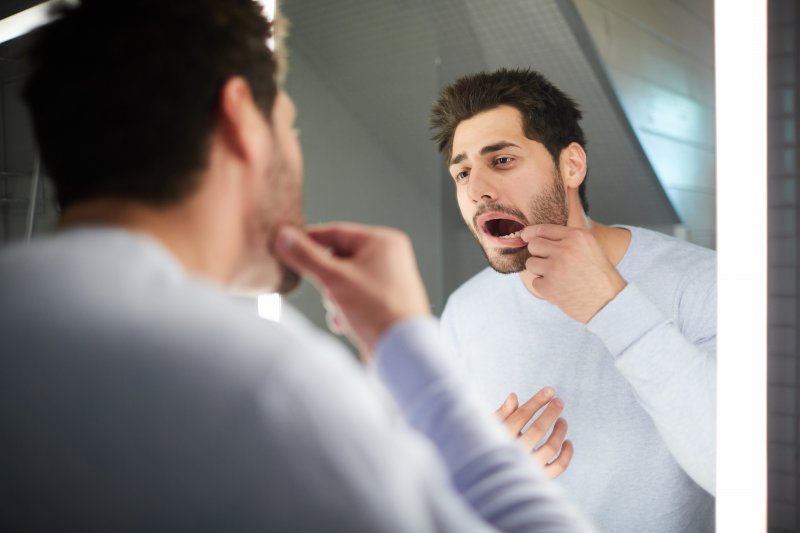 Man trying to place knocked-out tooth back into his mouth