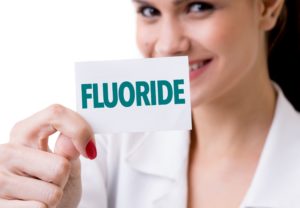 Woman holding fluoride card