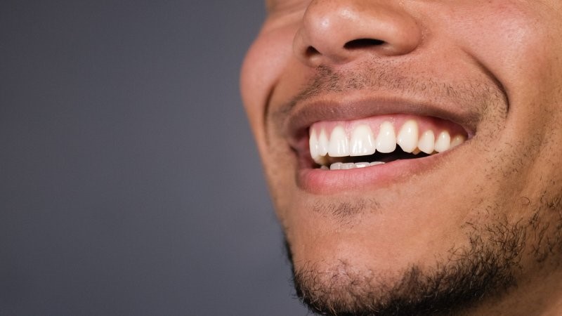 closeup of person who received crown lengthening treatment smiling 