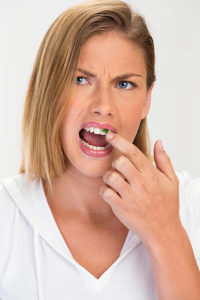 Woman with food stuck in teeth