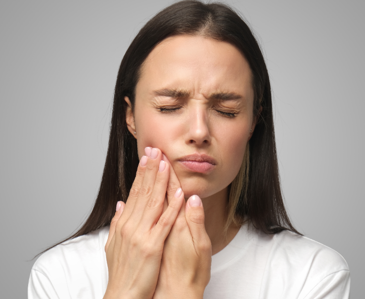 Woman holding jaw in pain